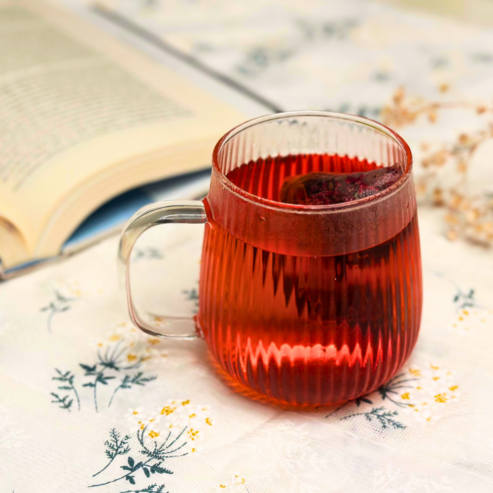 A soothing cup of herbal tea in a ribbed glass mug, perfect for unwinding after a long day.